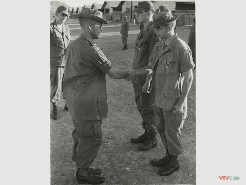38.CPT Kyle observes two A Co. soldiers receiving their ACMs.